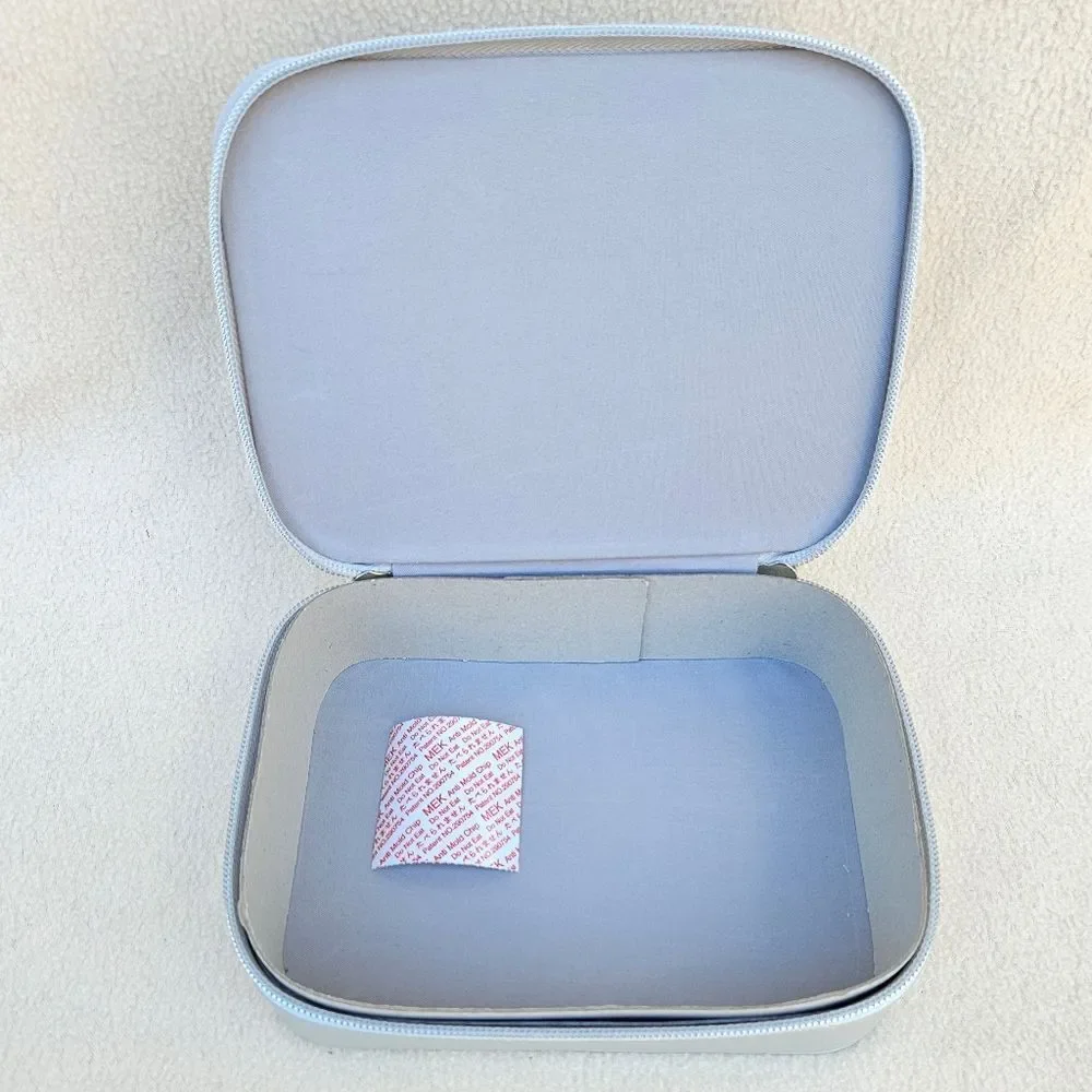 Neiman Marcus Silver Cosmetic Case with Eyelashes on the Front
